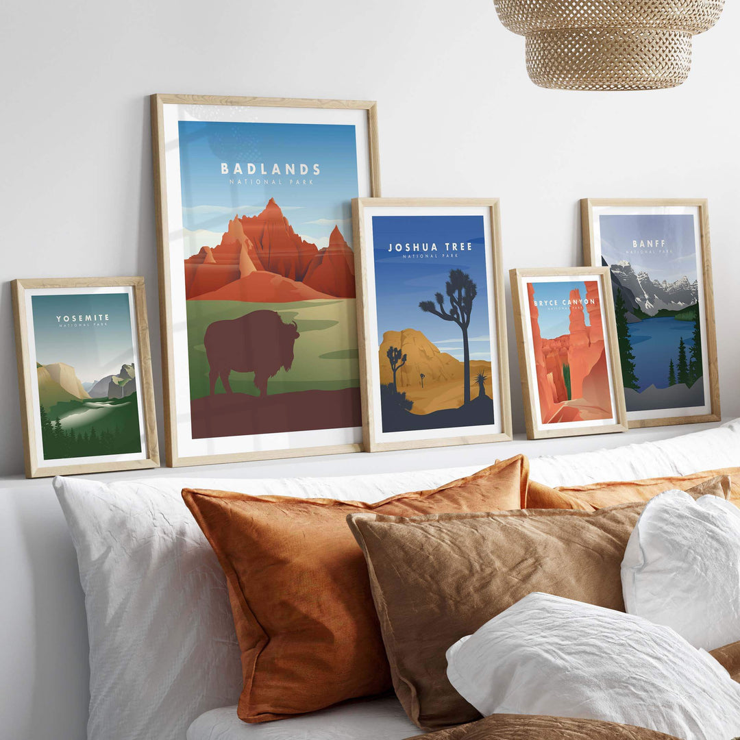 Framed vintage-inspired travel posters featuring Badlands, Joshua Tree, and more, styled in a cozy home decor setting.