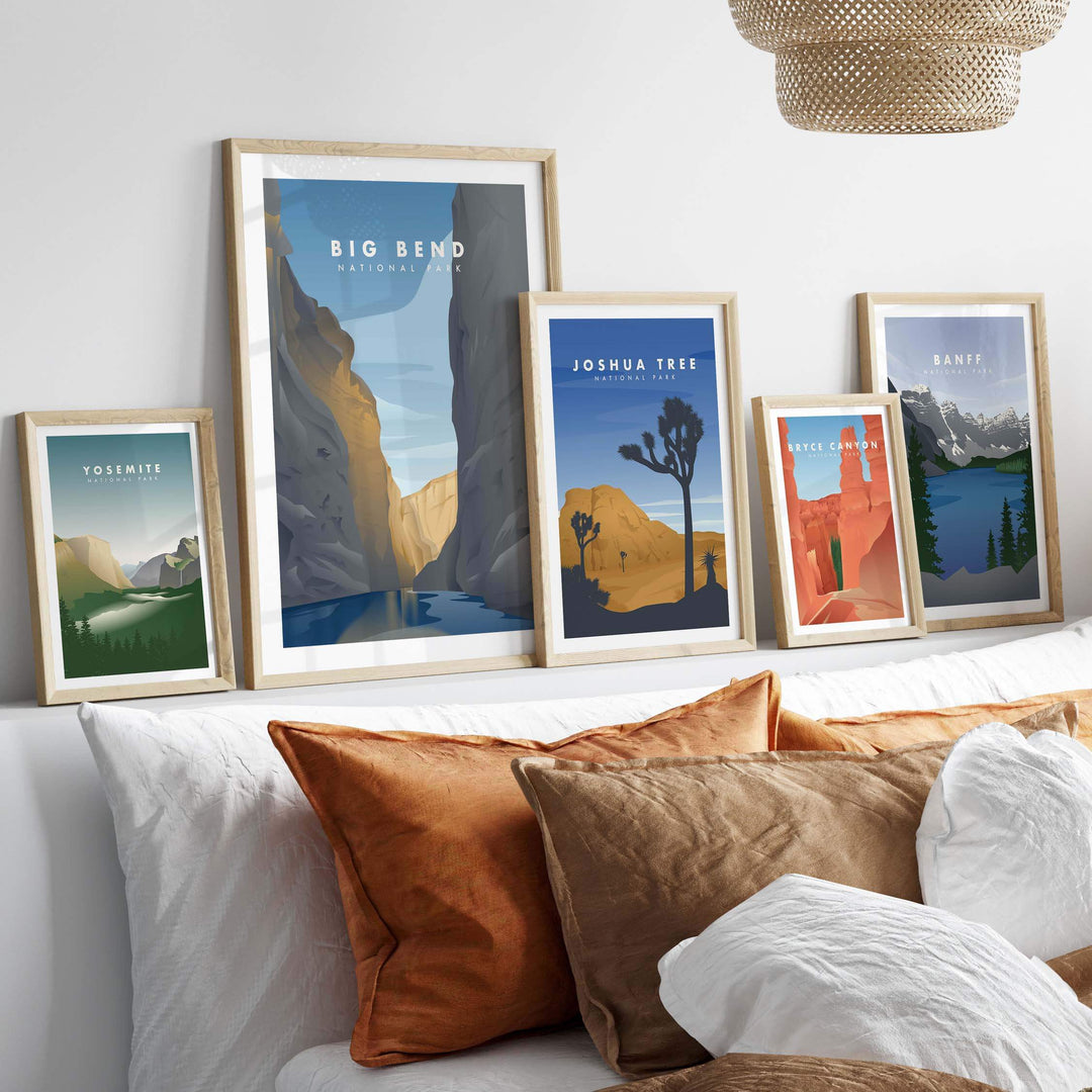 Framed Big Bend National Park and other national park art prints displayed on a wall above a cozy couch.