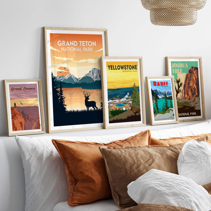 Framed Grand Teton National Park poster among other national park prints on wall above cozy bed.