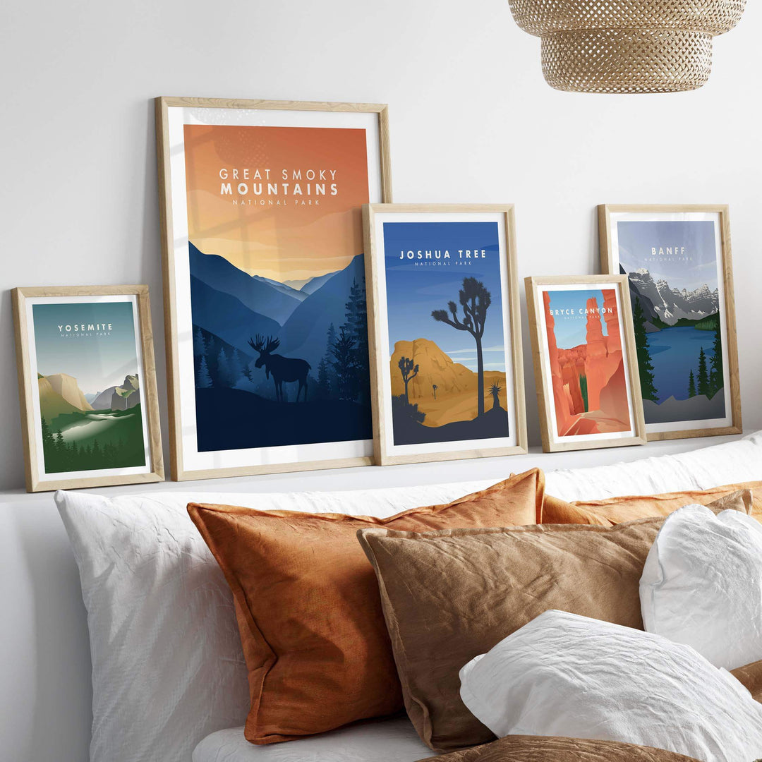 Framed Great Smoky Mountains and other national park art prints displayed on a wall with decorative pillows.