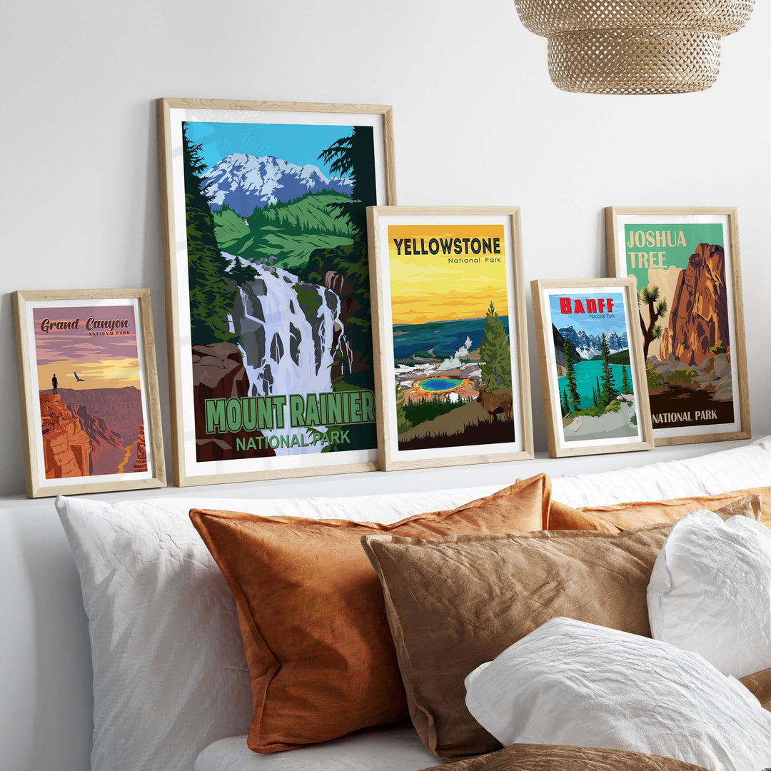 Framed Mount Rainier National Park print and vintage posters displayed on a wall above a cozy bed.