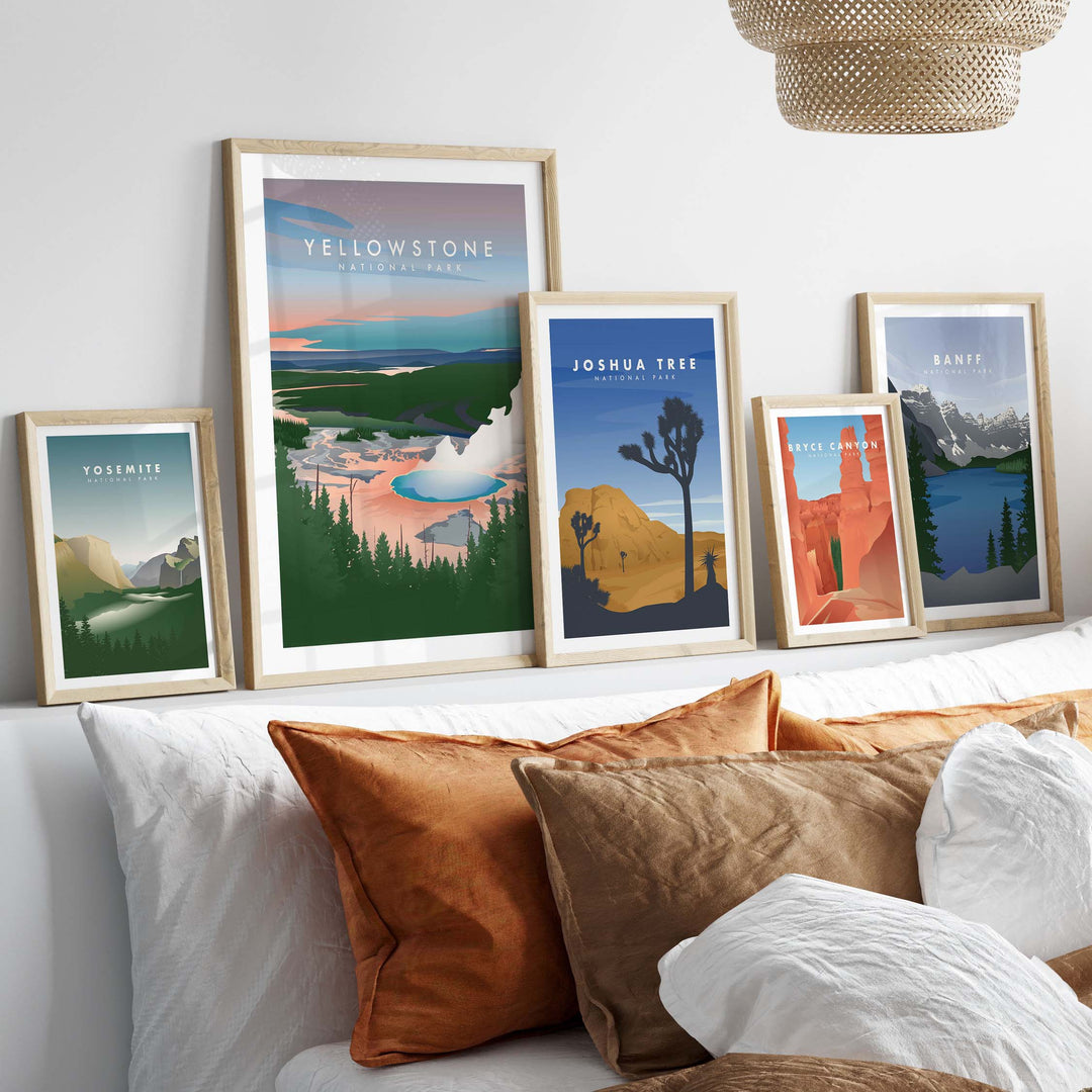 Vintage travel posters featuring Yosemite, Yellowstone, Joshua Tree, and more, elegantly displayed above cozy pillows.