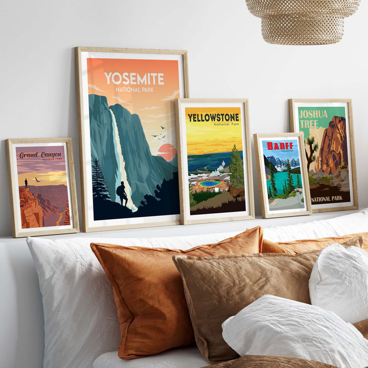 Yosemite National Park poster among framed art prints of national parks on a stylish bed with decorative pillows.