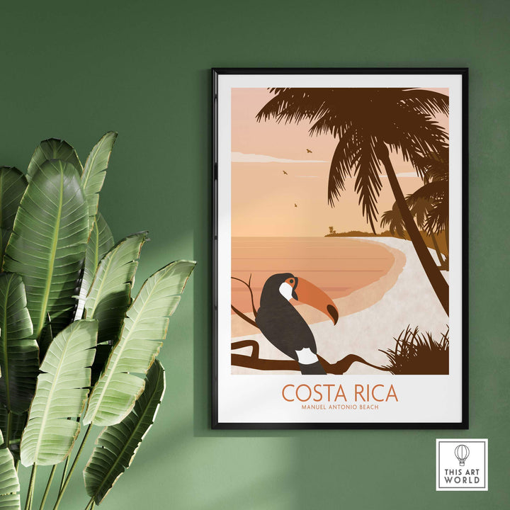 Costa Rica print poster featuring a toucan and tropical beach scene, framed on a green wall with plants.