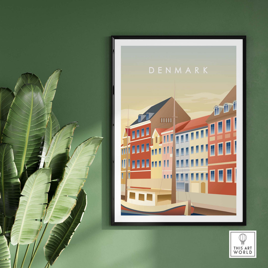 Denmark Wall Art Poster featuring colorful vintage-inspired buildings and a serene water view, framed on a green wall.