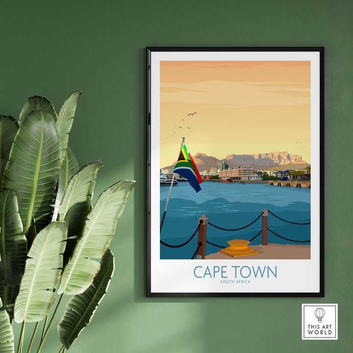 Cape Town print poster featuring a scenic view of Table Mountain and South African flag, framed against a green wall.