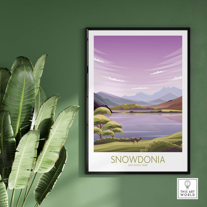 Snowdonia National Park art print featuring mountains and lake in a minimalist style, framed on a green wall.