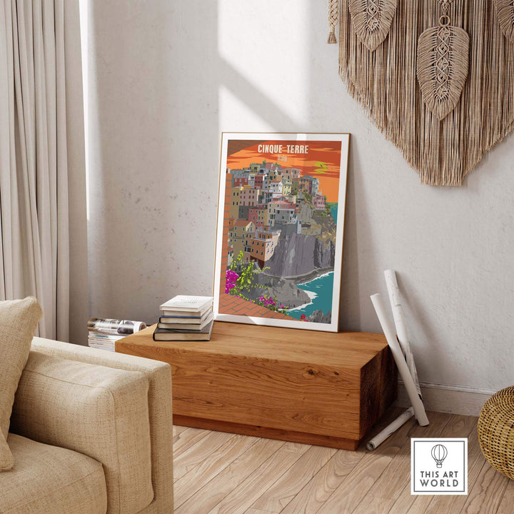 Vintage Cinque Terre Italy poster print on a wooden table in a cozy living room setting.