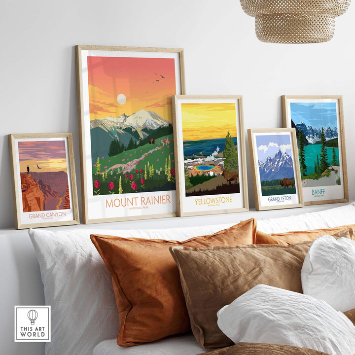 Framed Mount Rainier, Yellowstone, Grand Canyon, Grand Teton, and Banff art prints displayed on a stylish couch.