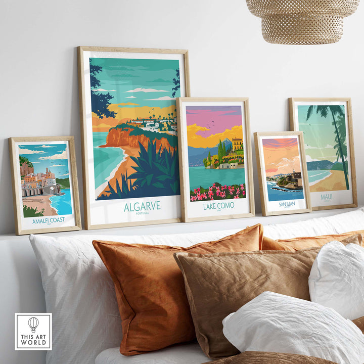 Framed Algarve print surrounded by vintage travel art posters on a stylish sofa, showcasing wanderlust inspiration.