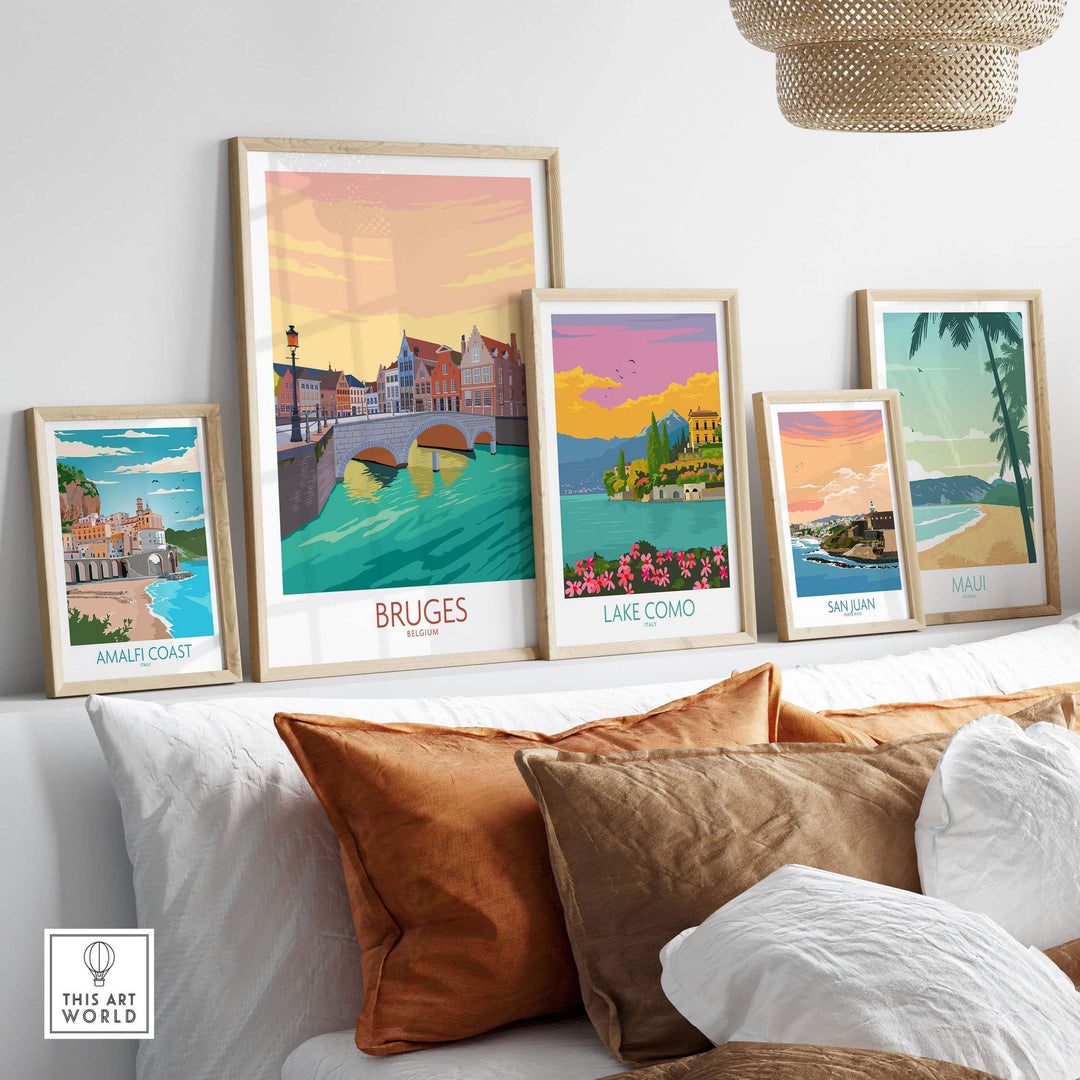 Bruges Belgium poster displayed among framed travel art prints on a stylish sofa, showcasing vibrant colors and nostalgic designs.
