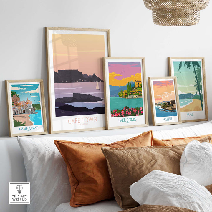 Stylish Cape Town poster print among other travel art prints on a stylish shelf with decorative pillows.