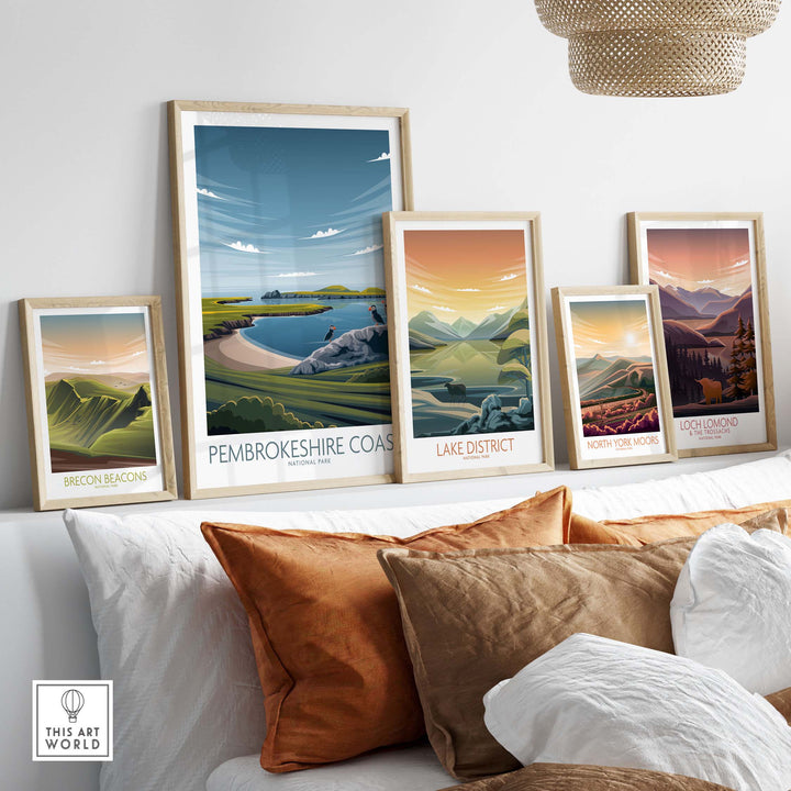 Framed Pembrokeshire Coast and National Park posters displayed on a stylish couch, showcasing nature-inspired artwork.