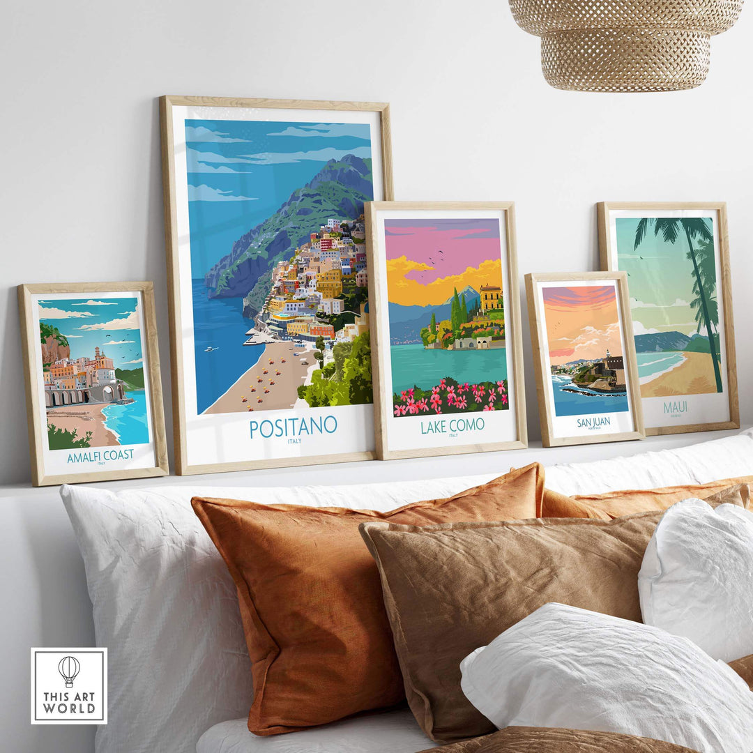 Framed travel art prints including Amalfi Coast, Positano, Lake Como, San Juan, and Maui on a stylish wall.