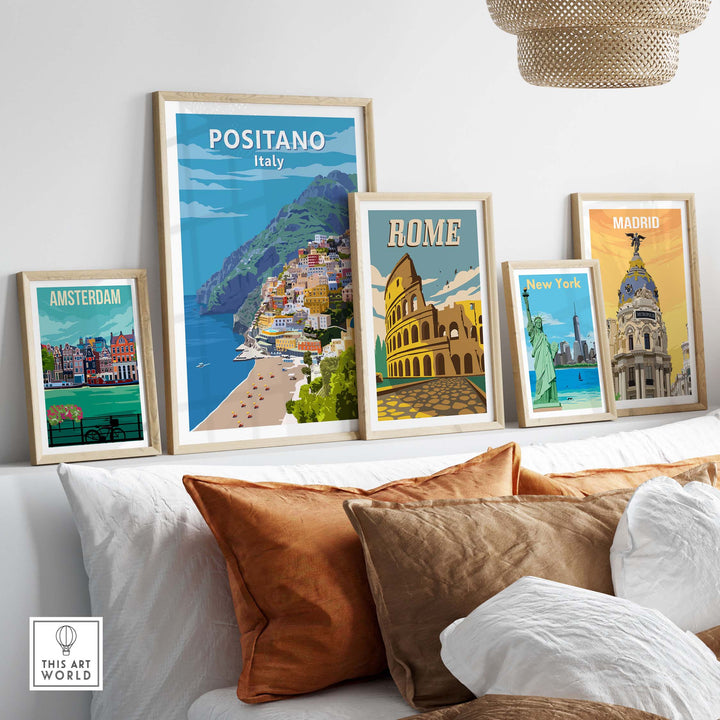 Positano Poster Print and other travel art prints displayed in elegant frames above a cozy sofa.