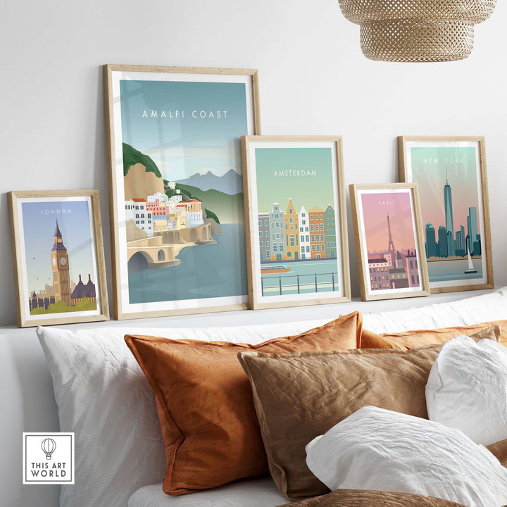Minimalist Amalfi Coast print displayed among vintage city posters in a modern living room.
