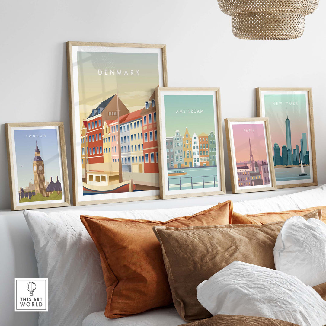 Framed Denmark wall art poster among other travel posters on a stylish couch in a modern living room.