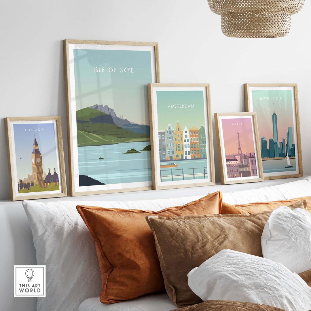 Stylish Isle of Skye poster print displayed among framed vintage travel art on a cozy sofa with decorative pillows.