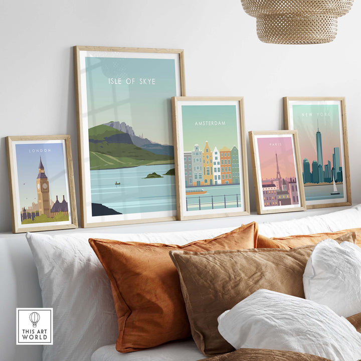 Stylish Isle of Skye poster print displayed among framed vintage travel art on a cozy sofa with decorative pillows.