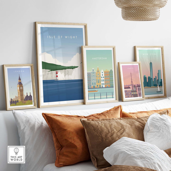 Framed Isle of Wight wall art poster among colorful travel-themed prints on a stylish couch.