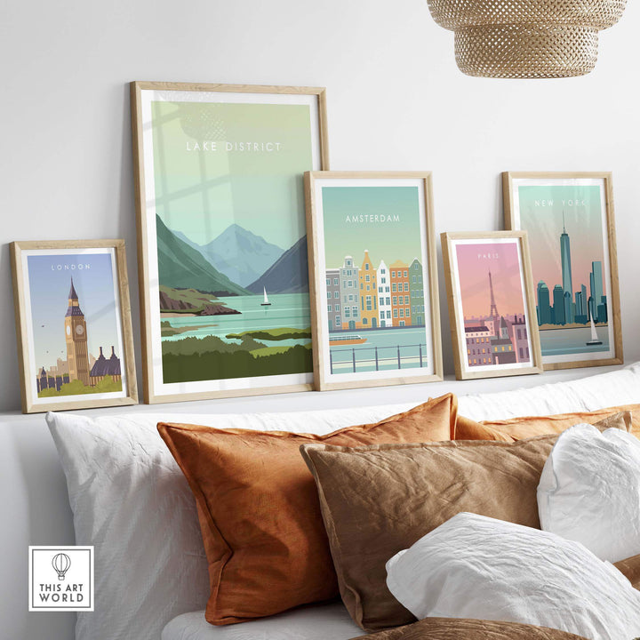 Lake District Print Wall Art Poster and travel-themed prints displayed above a cozy sofa, showcasing vibrant cityscapes.