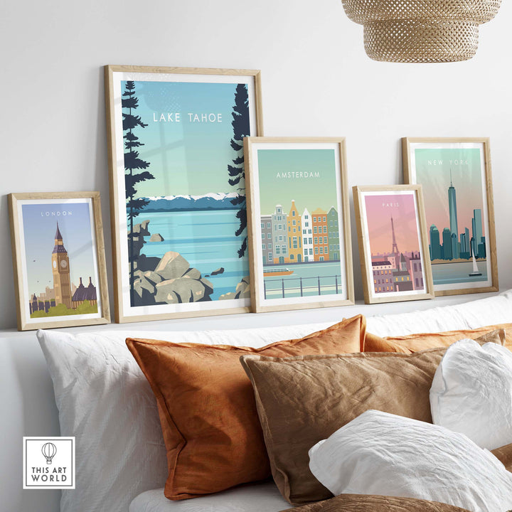 Lake Tahoe print wall art poster displayed among other city travel posters on a chic sofa in a styled living room.