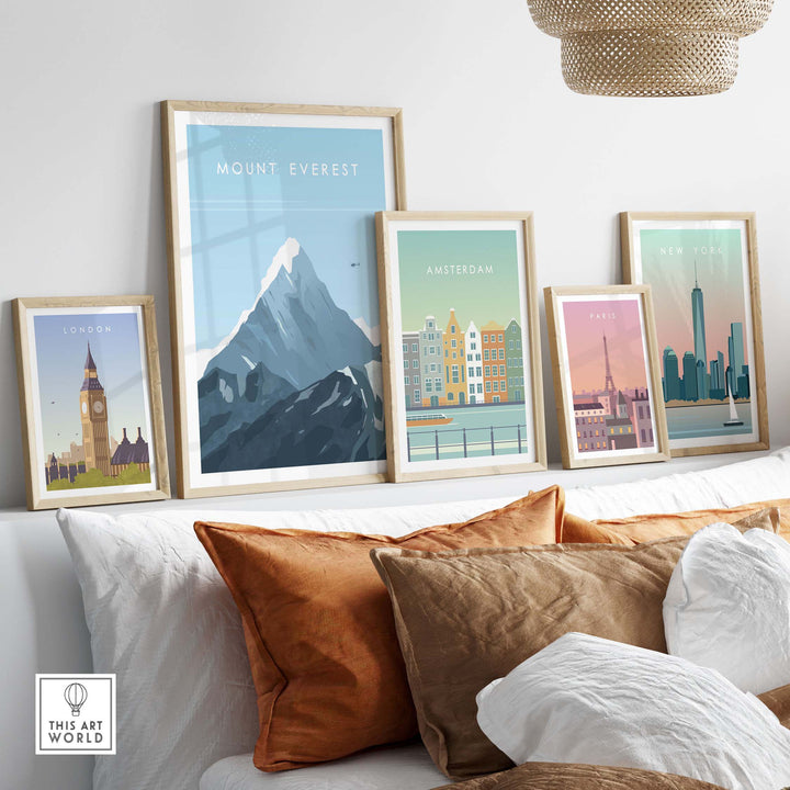 Mount Everest poster with vintage travel prints displayed on a stylish couch with decorative pillows.