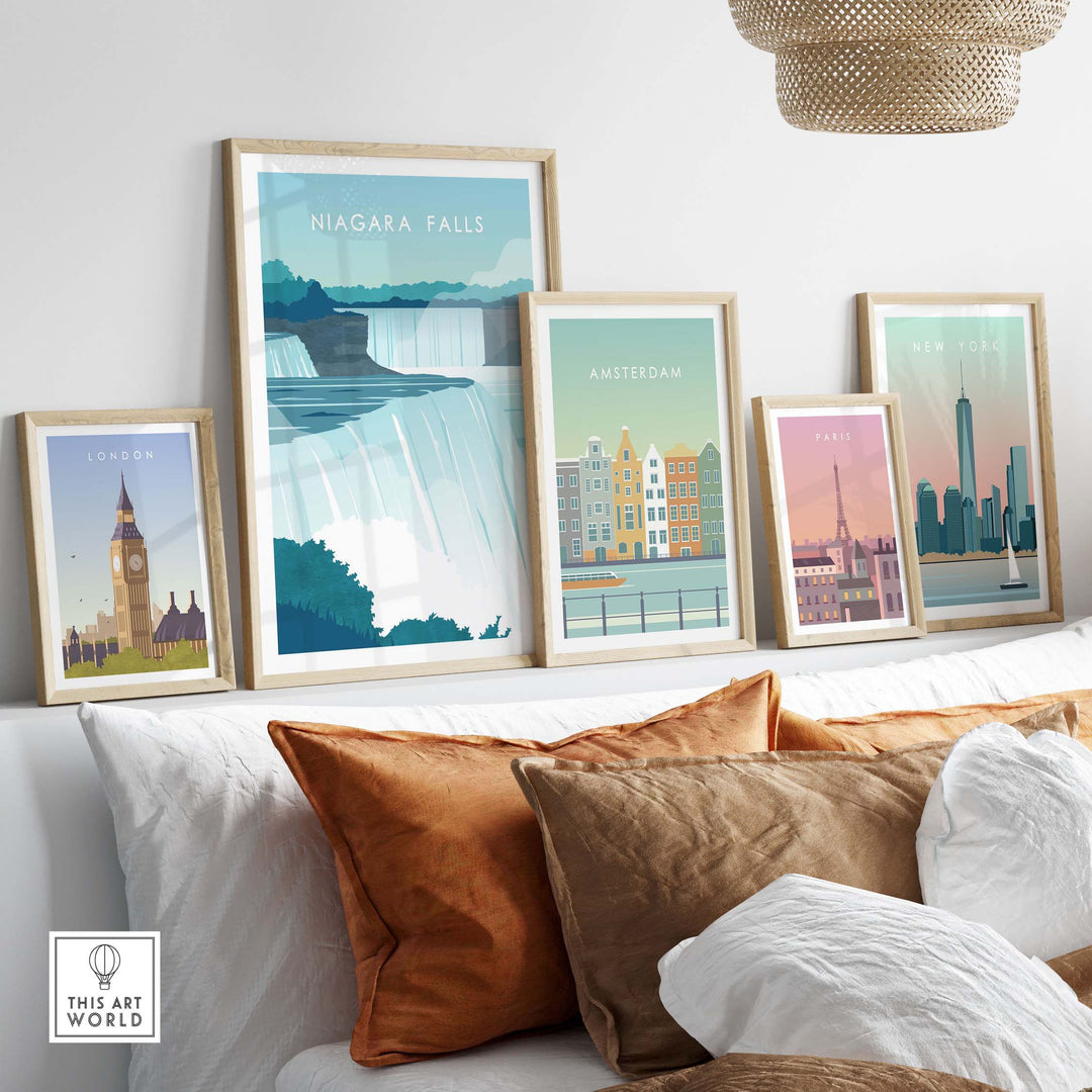 Framed Niagara Falls wall art poster among other city travel prints on a stylish living room sofa.