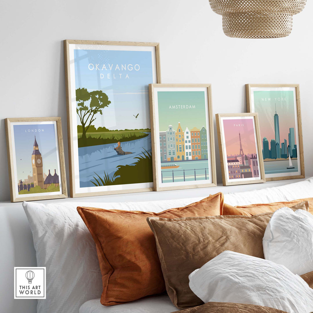 Gallery of vintage travel posters including Okavango Delta, London, Amsterdam, and Paris prints on a stylish sofa.