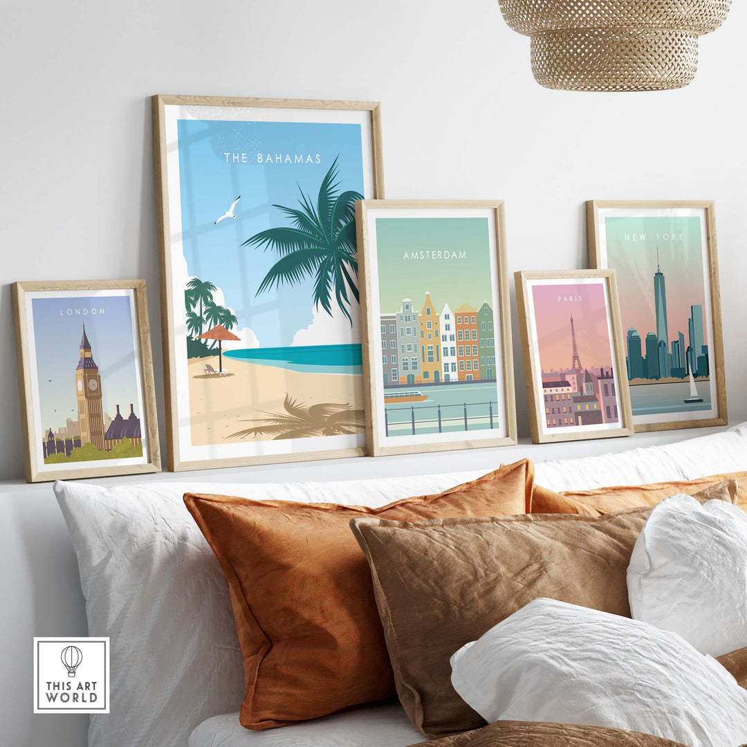 Framed travel poster prints featuring The Bahamas, London, Amsterdam, Paris, and New York on a stylish couch.
