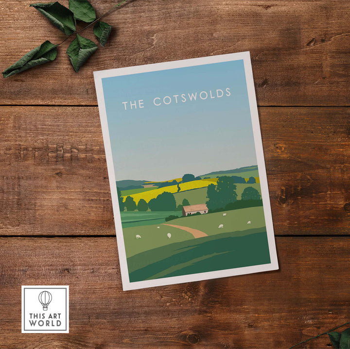 The Cotswolds poster print featuring a scenic landscape on a rustic wooden table.