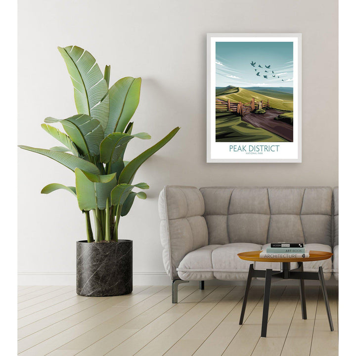 Stylish interior featuring a Peak District National Park art print in a modern living room with a plant.