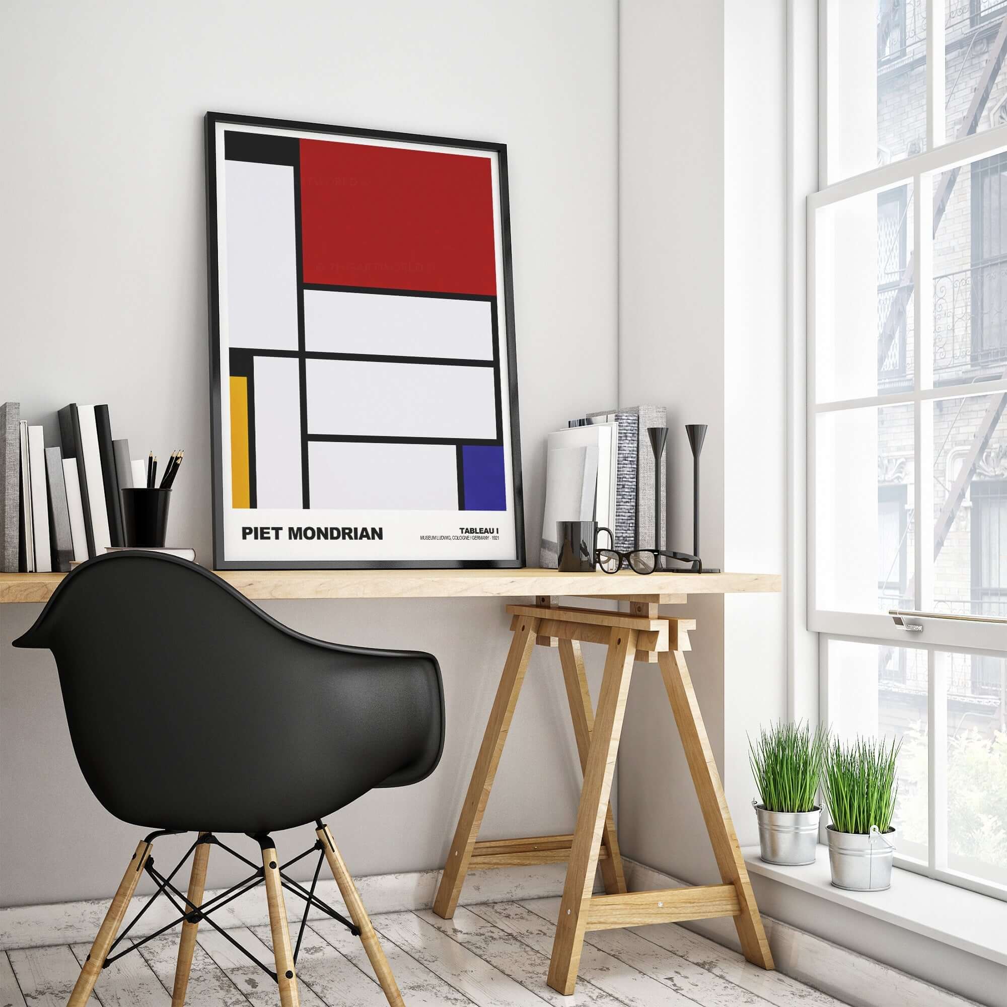 Piet Mondrian abstract art print displayed in a stylish modern workspace with a black chair and natural light.