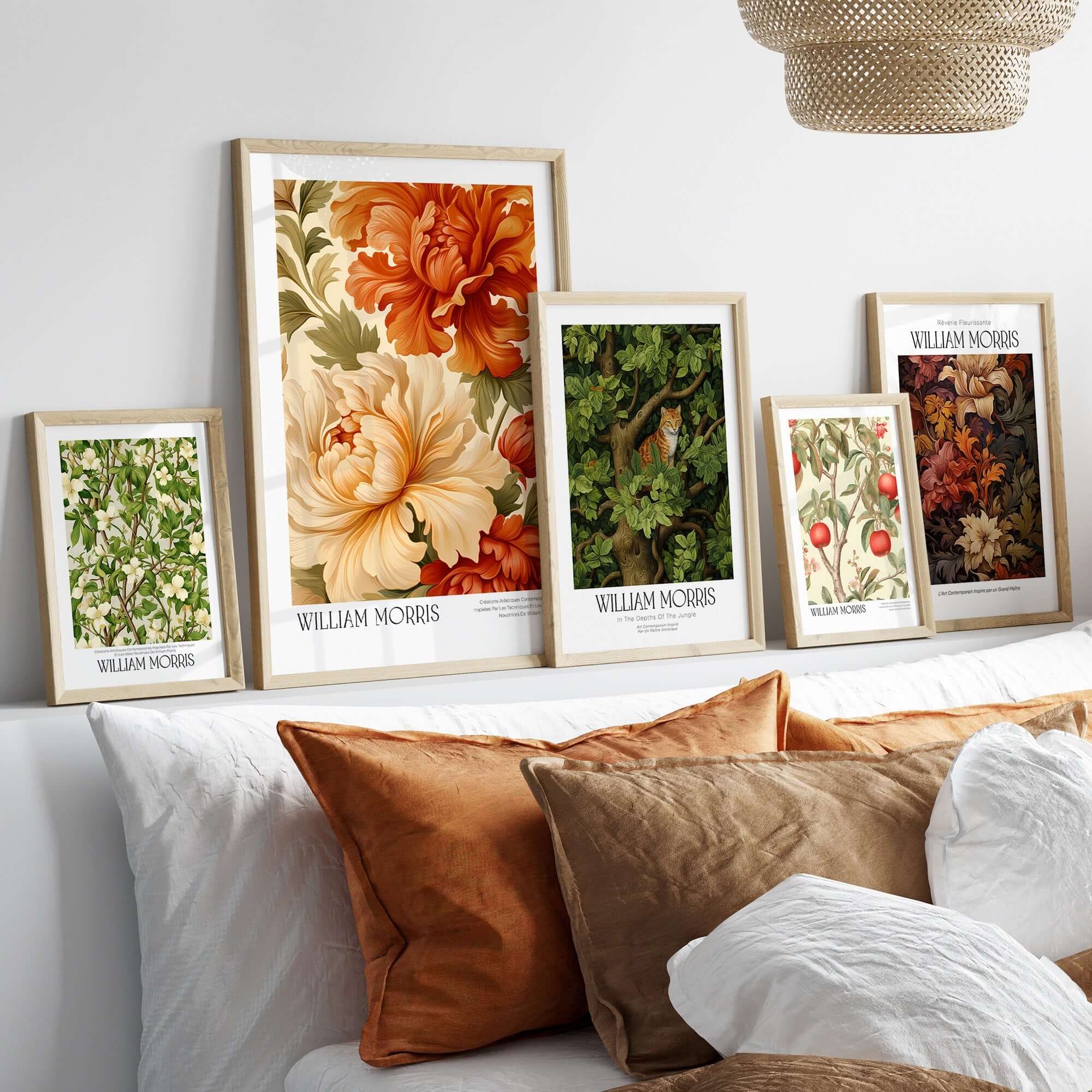 Collection of William Morris art prints displayed above a bed, showcasing floral designs and framed posters.