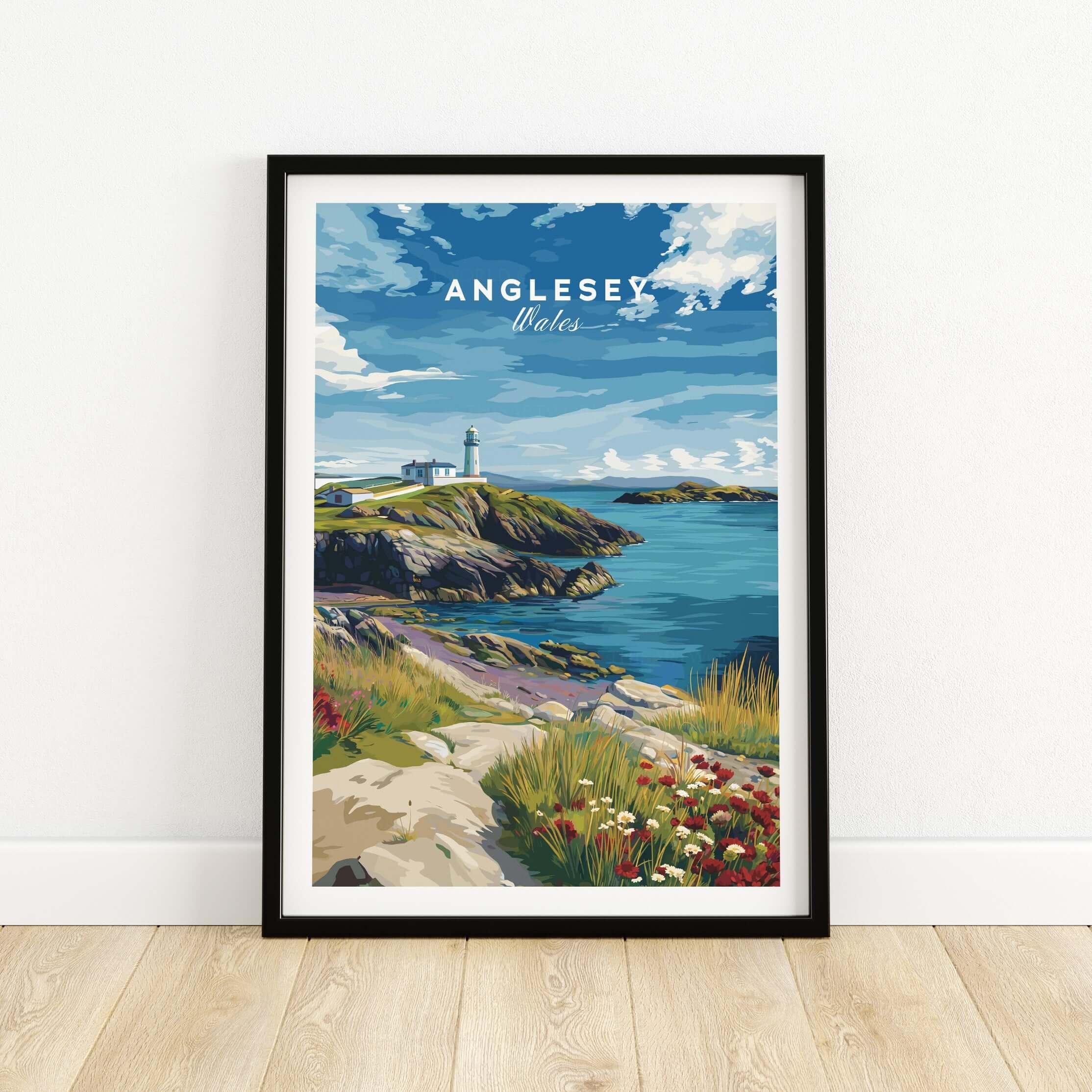 Anglesey Wales travel poster print in black frame, coastal landscape with lighthouse and wildflowers