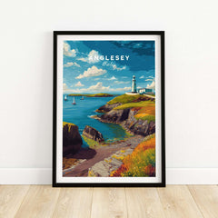 Anglesey Wales travel poster art print in black frame featuring coastal landscape and lighthouse