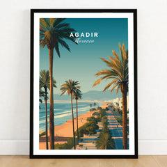 Agadir Travel Poster Print Morocco - Palm Trees in a black wooden frame leaning against a white wall on a light wooden floor