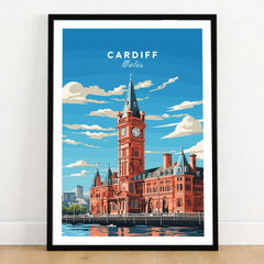 Cardiff Travel Poster in a black wooden frame leaning against a white wall on a light wooden floor