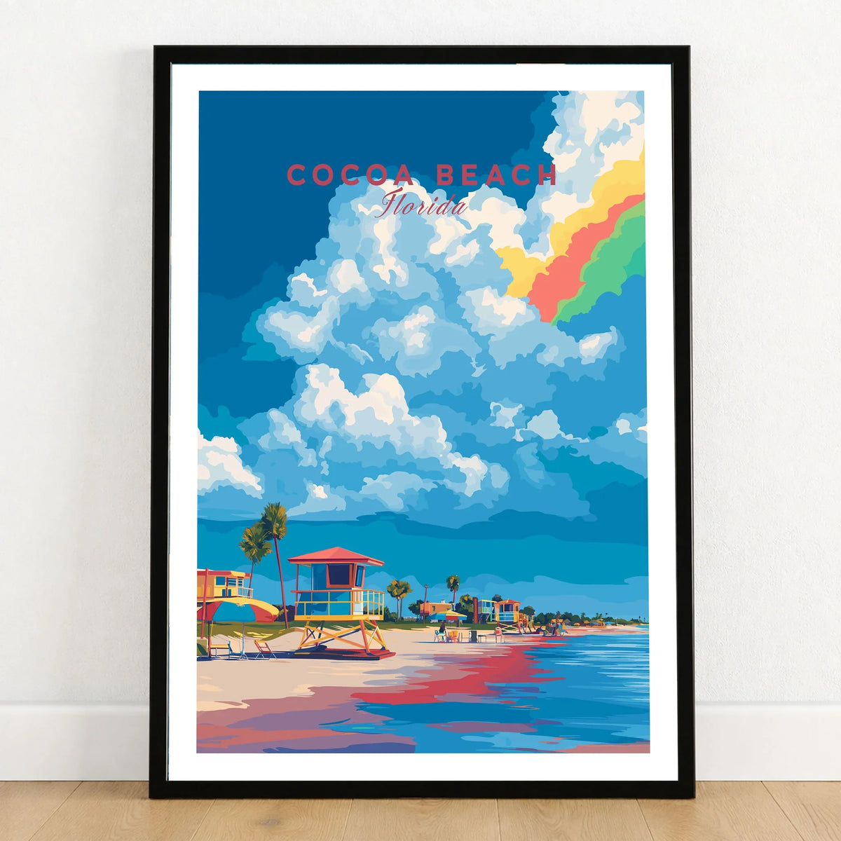 Cocoa Beach Lifeguard Stand Print - Florida Beach Wall Art in a black wooden frame leaning against a white wall on a light wooden floor