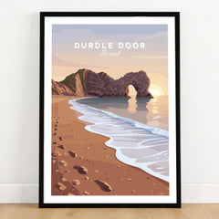 Durdle Door Travel Poster – Jurassic Coast Sunset Art in a black wooden frame leaning against a white wall on a light wooden floor