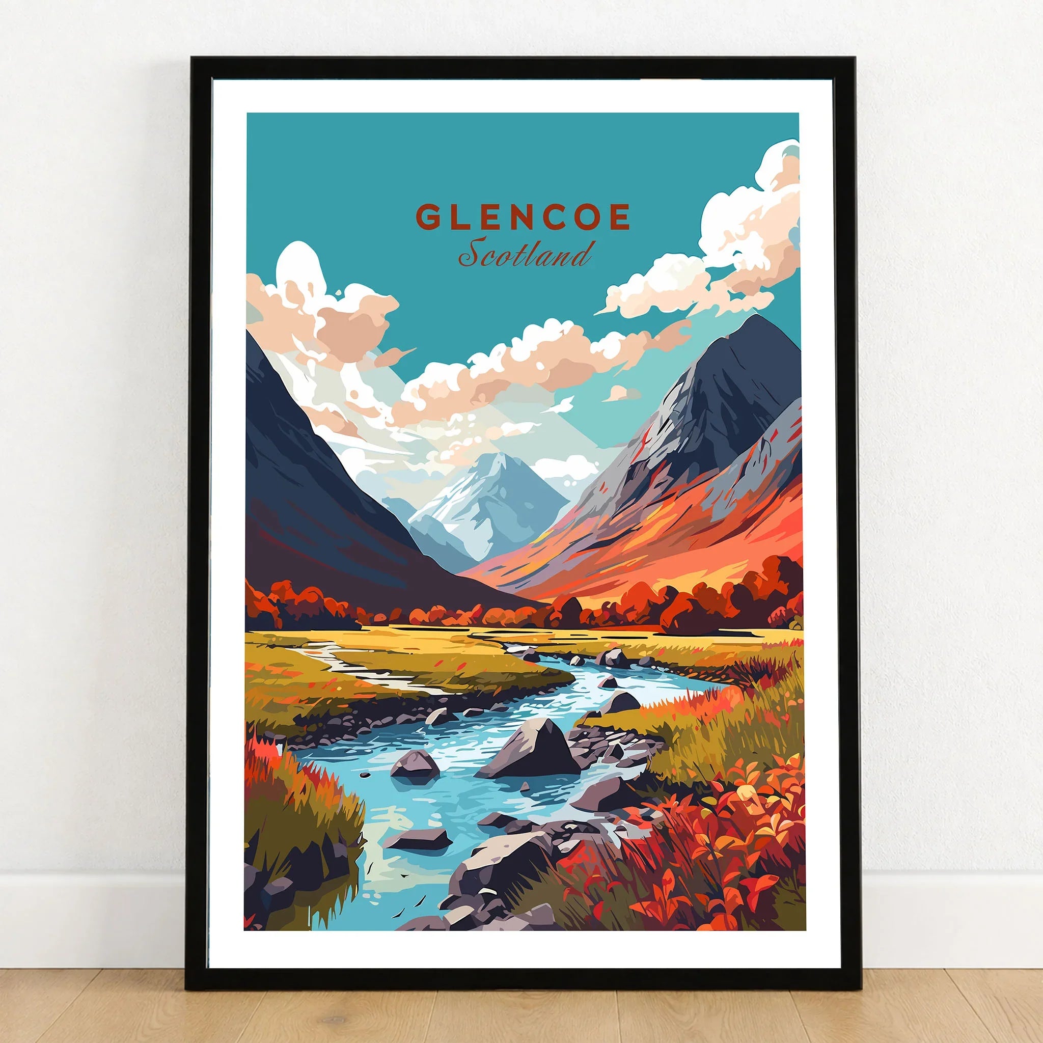Glencoe Poster Print in a black wooden frame leaning against a white wall on a light wooden floor