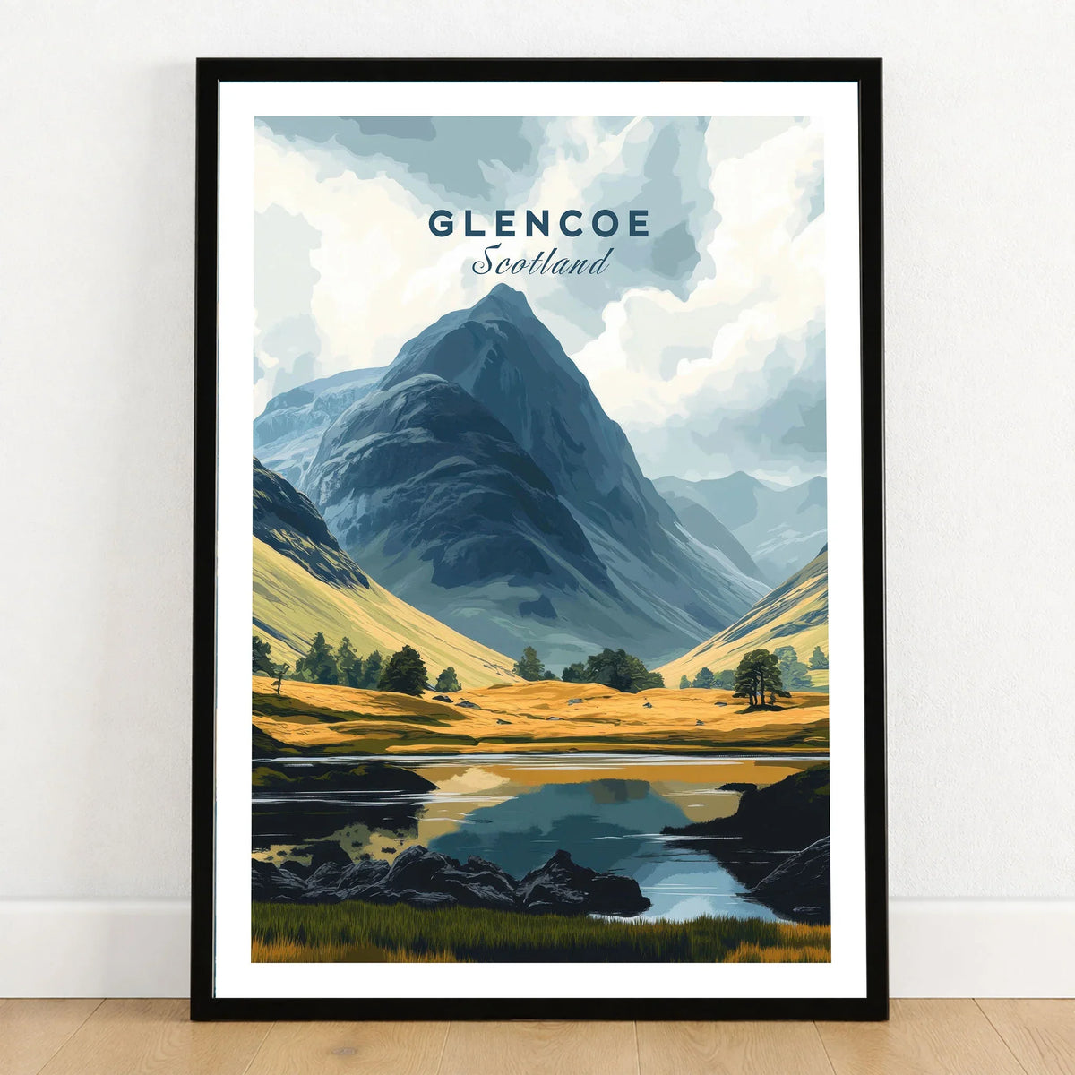 Glencoe Travel Print in a black wooden frame leaning against a white wall on a light wooden floor