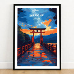 Hakone Wall Art Japan Torii Gate Sunset Reflections Poster - Vibrant Lake Ashi Print in a black wooden frame leaning against a white wall on a light wooden floor