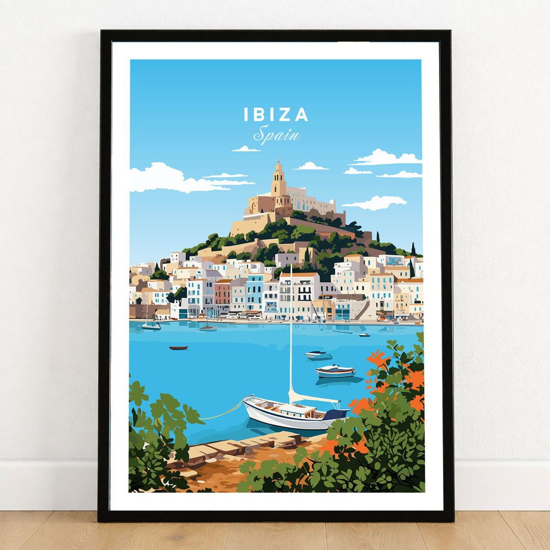 Ibiza Print in a black wooden frame leaning against a white wall on a light wooden floor