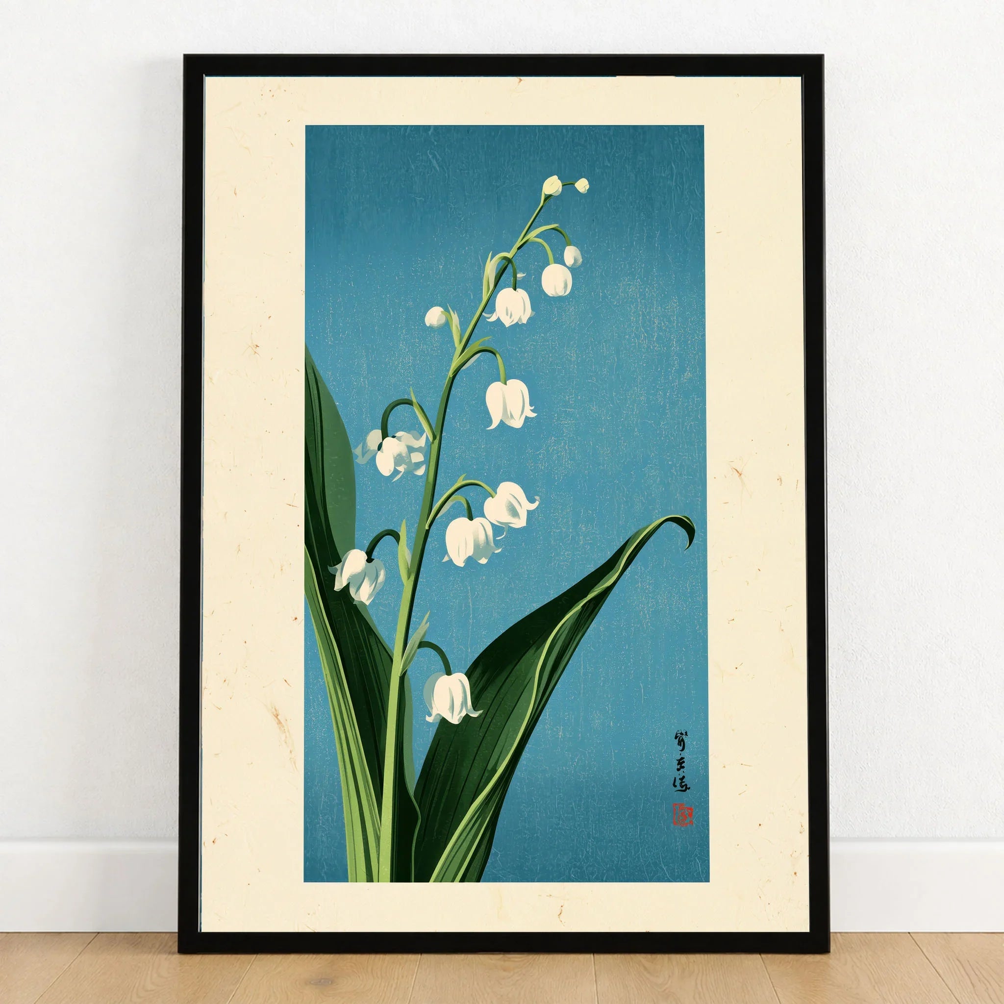 Lily of the Valley Art Print – Blue Japanese Botanical Wall Art — art print in black frame on wooden floor