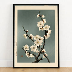White Plum Blossom Art Print – Japanese Botanical Wall Art — art print in black frame on wooden floor