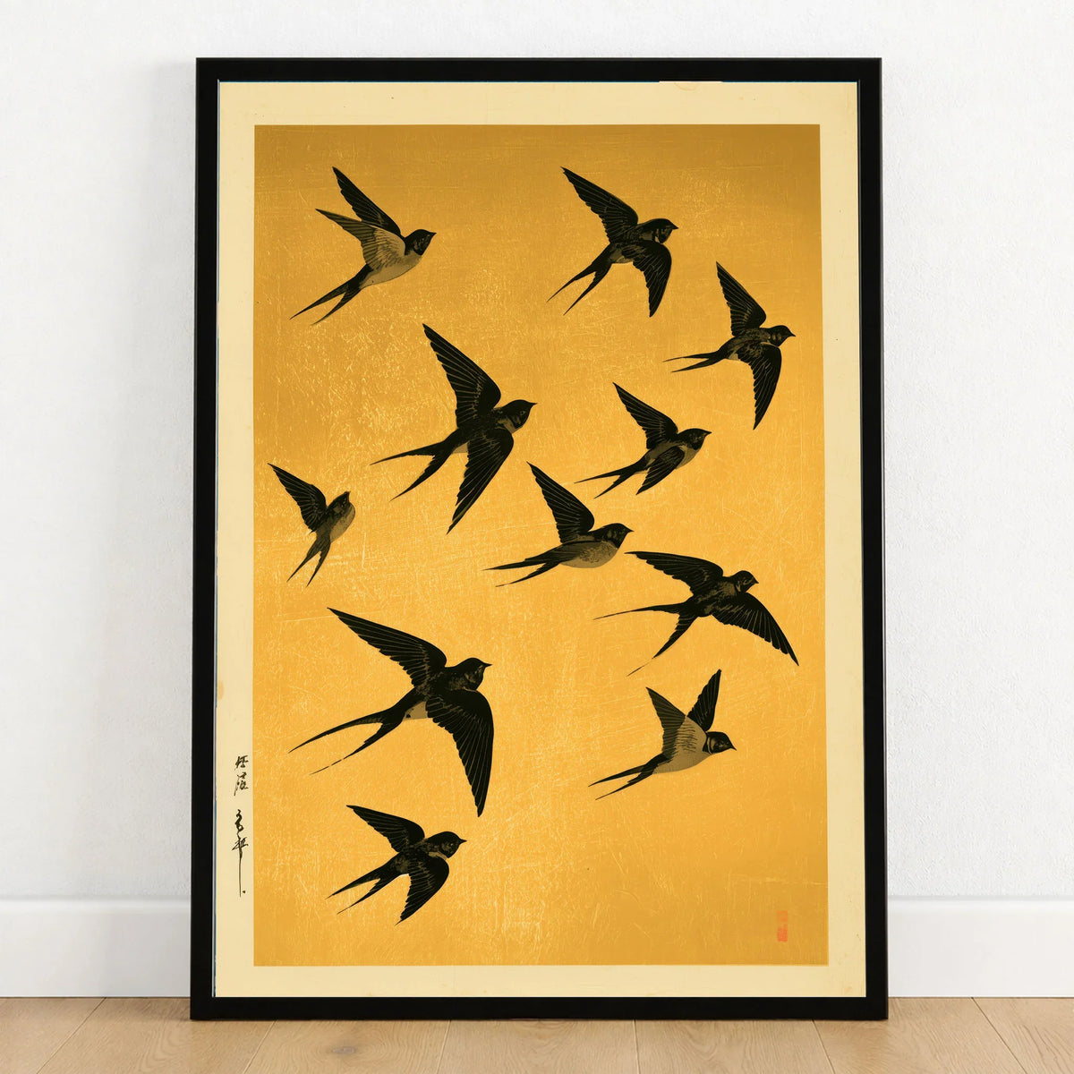 Flying Swallows Wall Art – Vintage Japanese Gold Print — art print in black frame on wooden floor