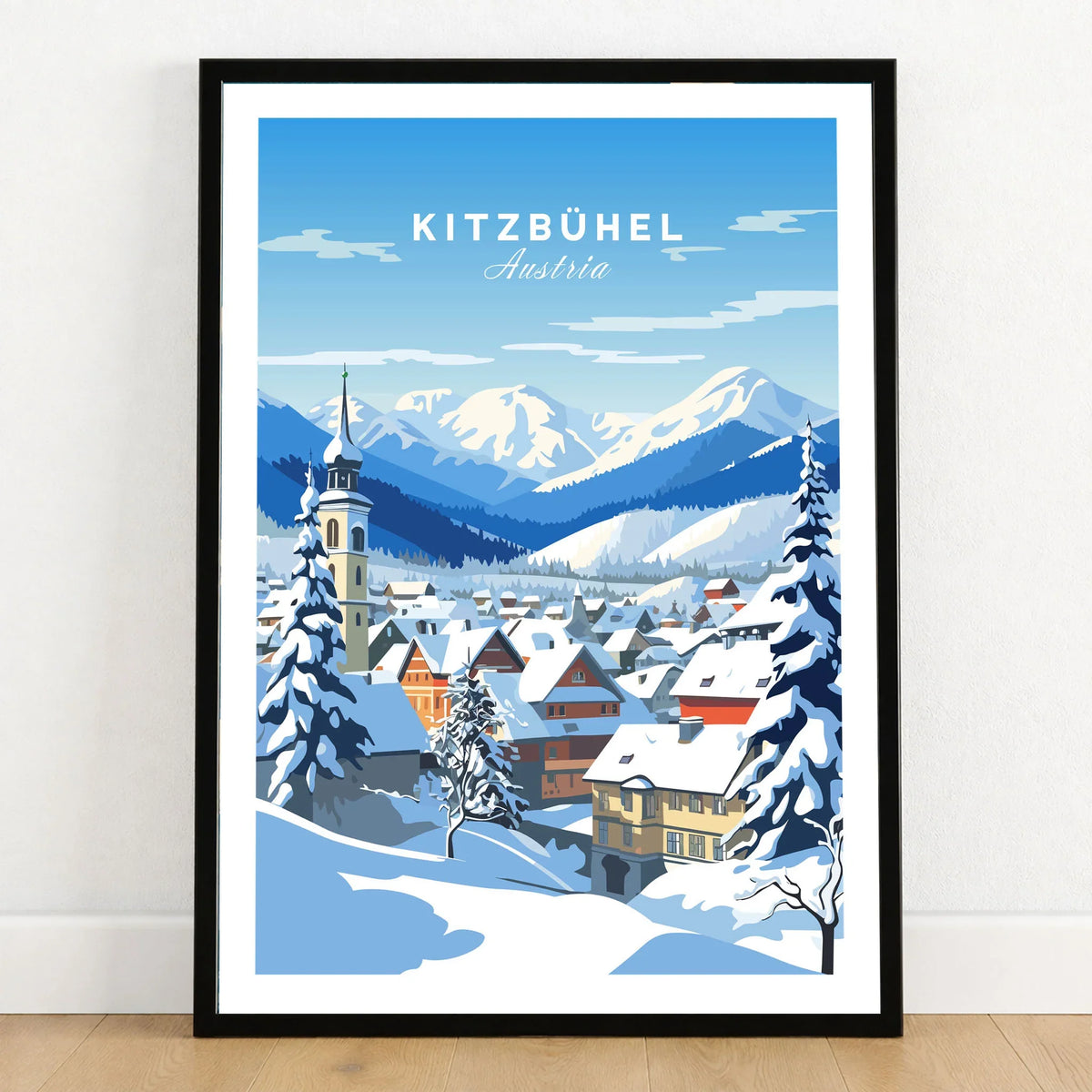 Kitzbuhel Poster in a black wooden frame leaning against a white wall on a light wooden floor