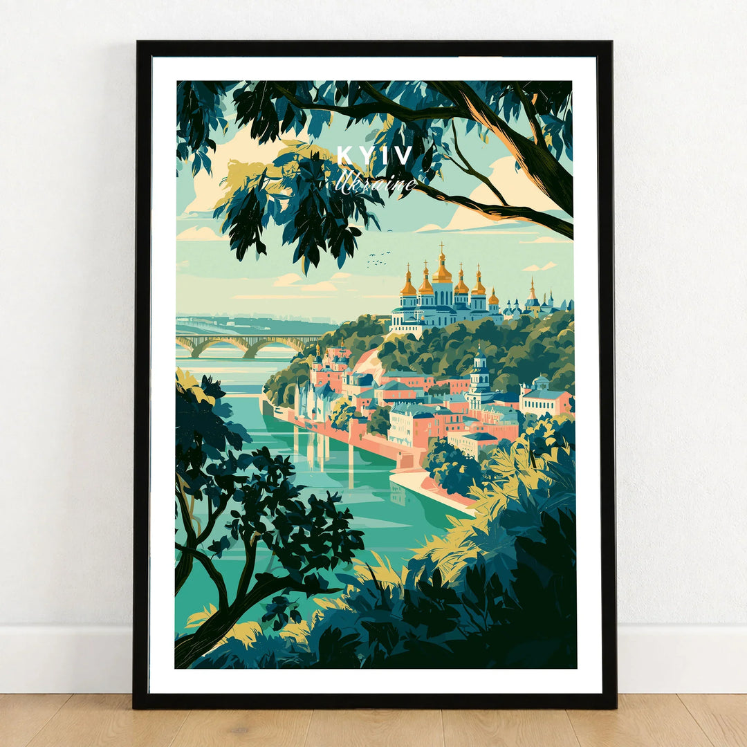 Kyiv Ukraine Golden Domes Travel Poster — golden domes on a wooded bluff above the Dnipro river, shown as art print in black frame on wooden floor
