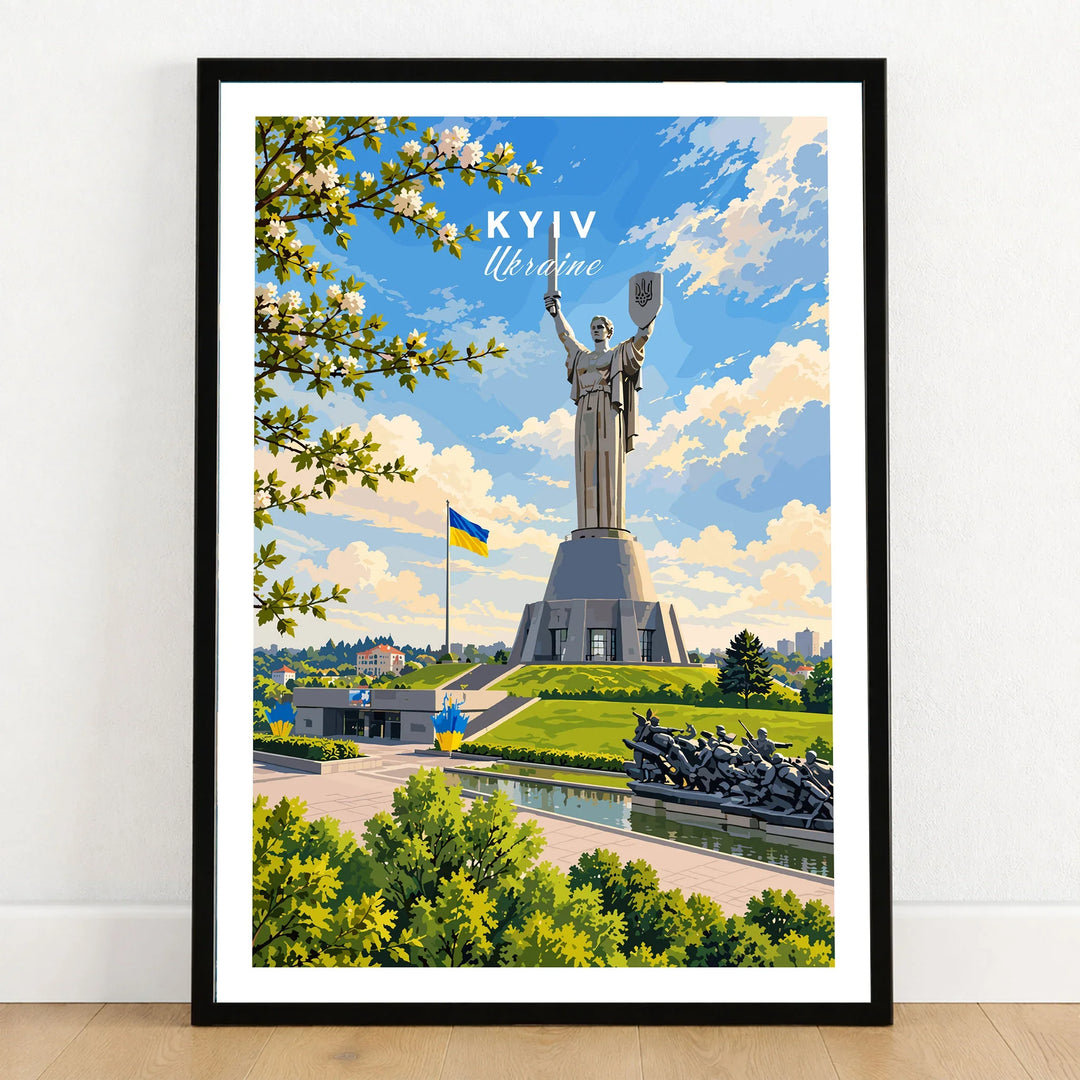 Kyiv Ukraine Motherland Monument Travel Poster — the Motherland Monument under spring blossom with the Ukrainian flag flying, shown as art print in black frame on wooden floor